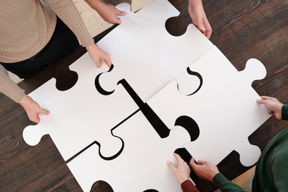 A person holding puzzle pieces representing different skills and competencies, symbolizing continuous improvement in professional development.